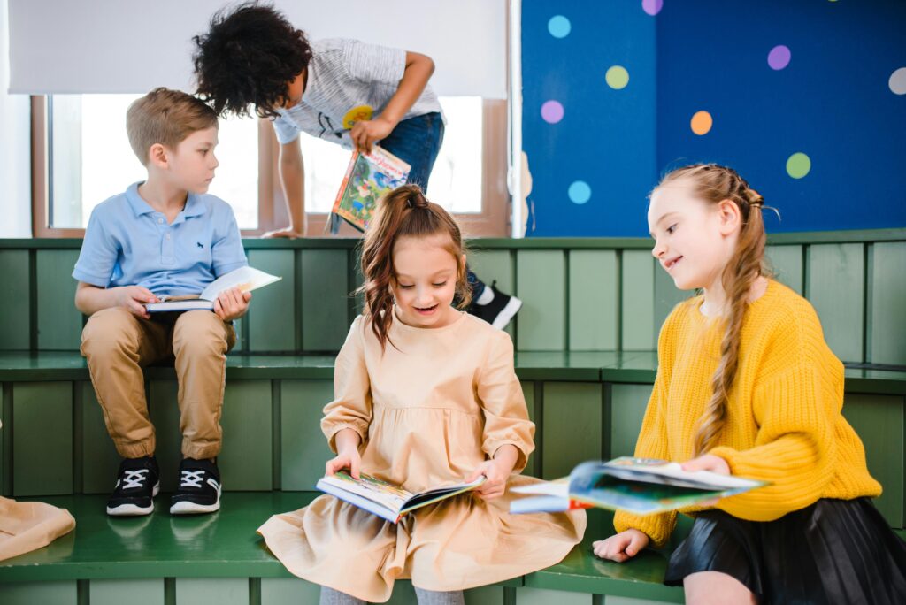 A group of children enjoying books in a vibrant indoor library setting.